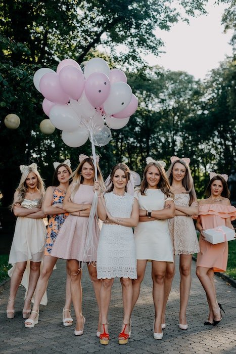 girls posing with bunch of balloons