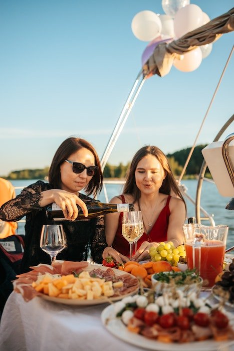 women having a birthday meal on a boat