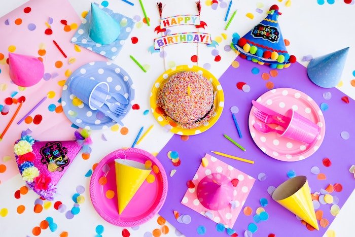 flat lay of colorful birthday decorations on a white table