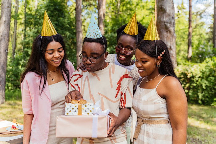 friends all wearing birthday hats as a birthday photoshoot idea