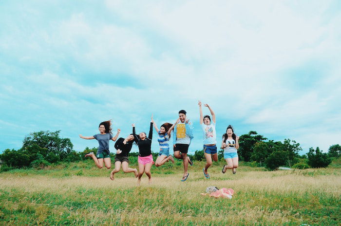 group of friends jumping in the air 