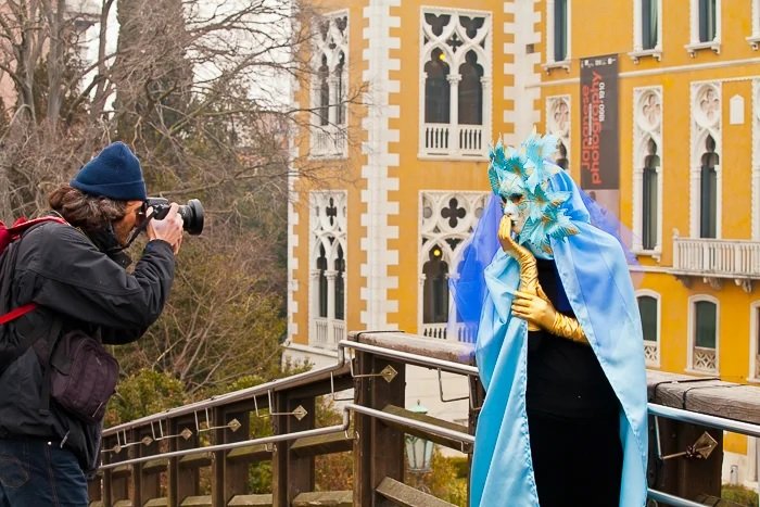 Man taking a photo of a person in a costume on a bridge