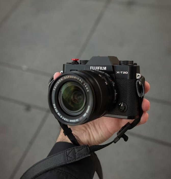 Hand holding a Fujifilm X-T20 camera