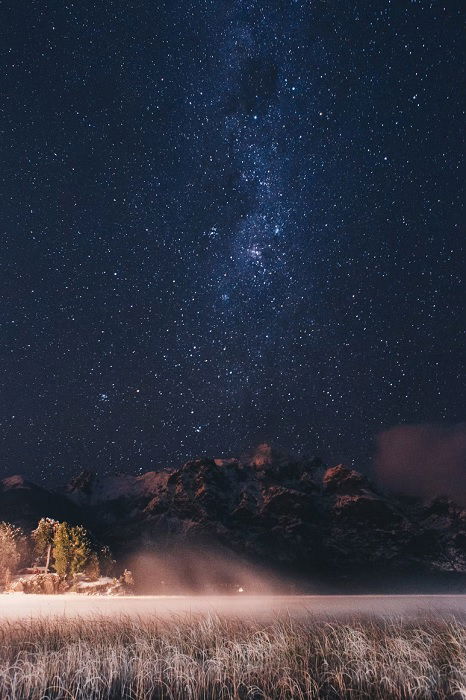 Image of a starry night sky above mountains