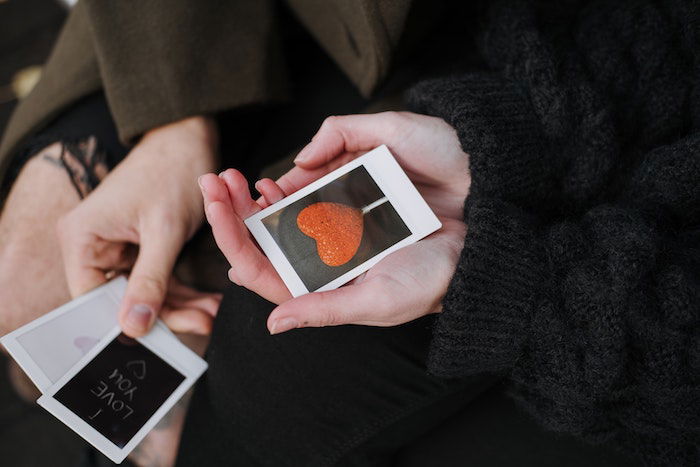 a photo of a hand holding an instant print photo