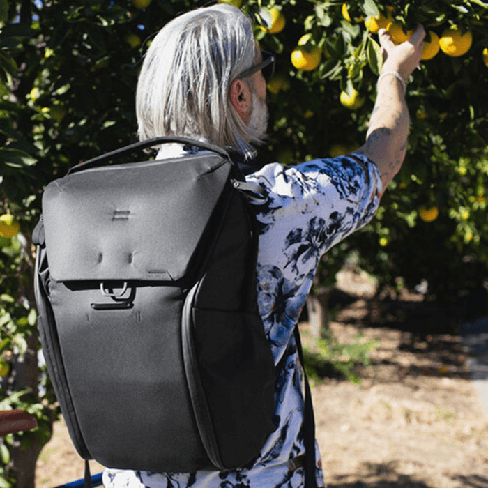 Man wearing a black Peak Design Everyday Backpack