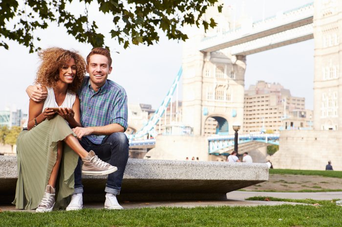 Couple sitting by Tower Bridge