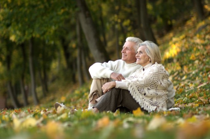 Mature couple sitting on grass