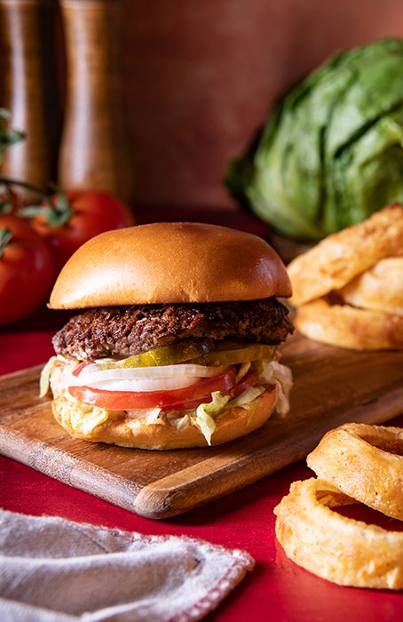 An image of a burger and onion rings shot with v flat world duo boards