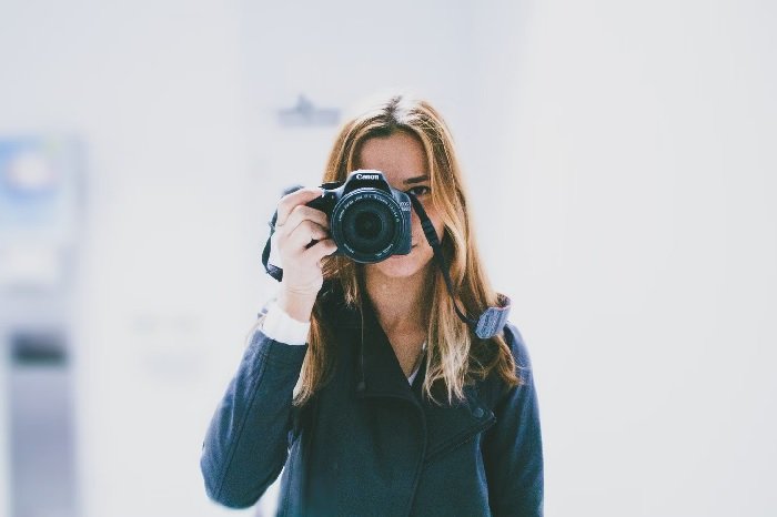 Girl holding a Canon camera to her face