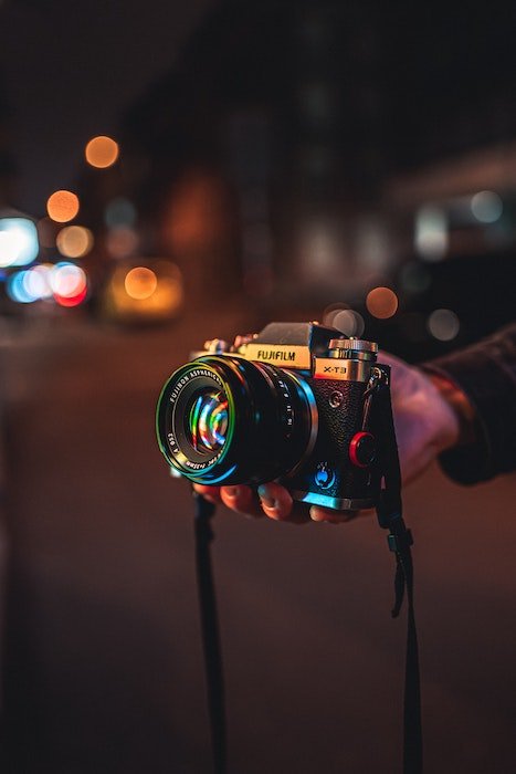 Close up of fuijifilm camera in the streets at night
