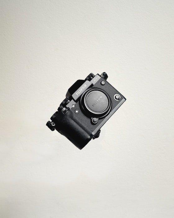 Fujifilm camera floating on white background
