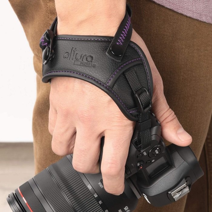 Photographer using an Altura hand strap with a DSLR camera