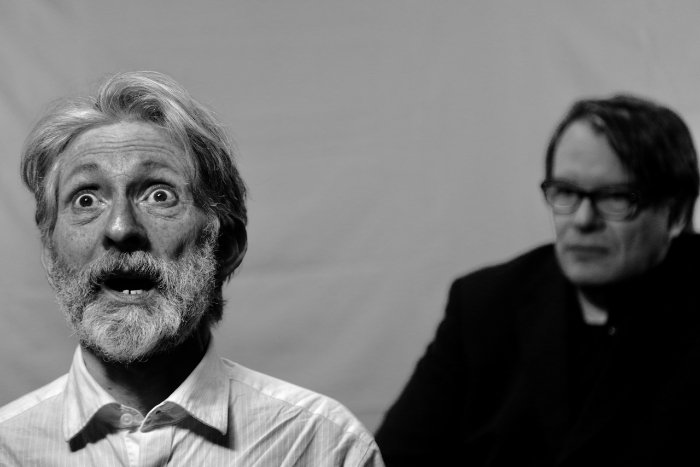 A black and white photo of two actors in a theatre