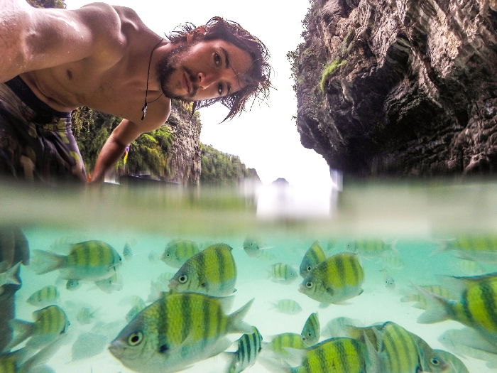 Underwater photo of man and fish