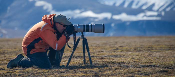 Picture of photographer kneeling with tripod