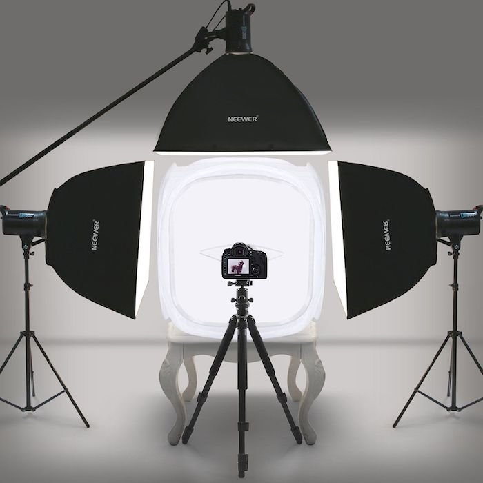 Light tent kit surrounded by soft boxes and a camera on a tripod