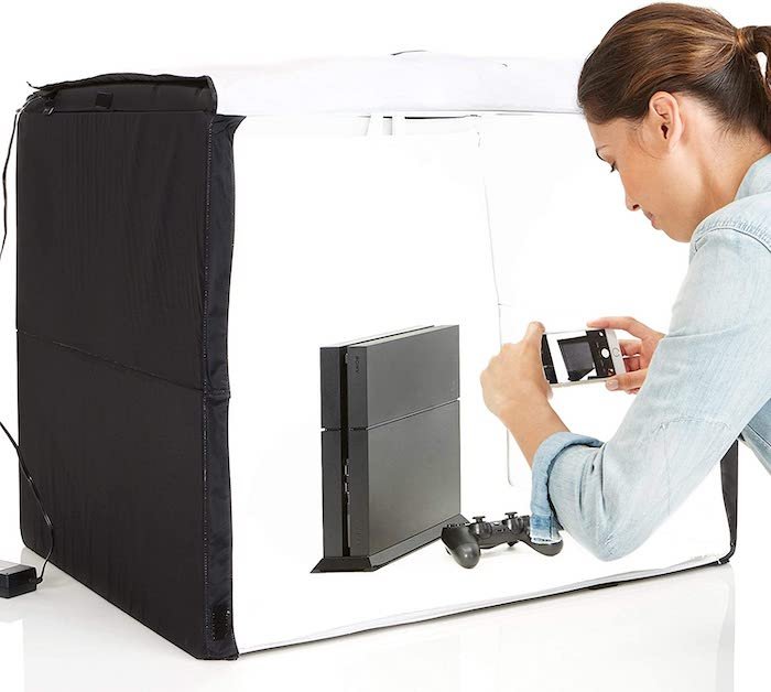 Photographer using Amazon Basics Portable Studio Box to shoot a product photo