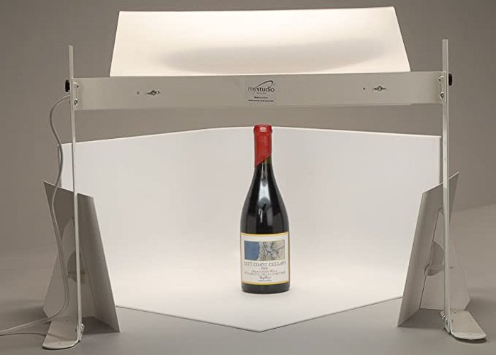 A wine bottle standing against a white cyclorama