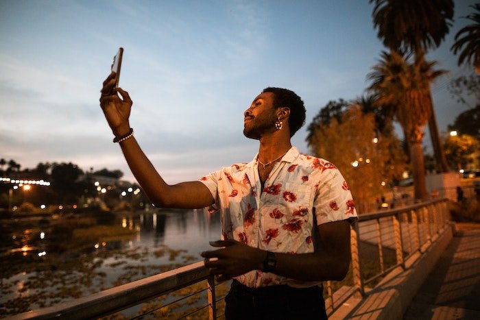 guy takes selfie on smartphone camera