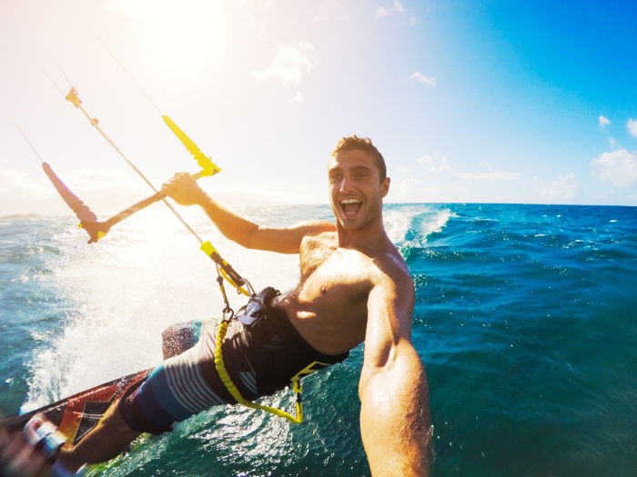 Action photo of a man kitesurfing on the sea