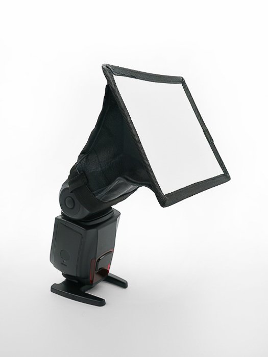 External camera speedlight with diffuser isolated on a white background.