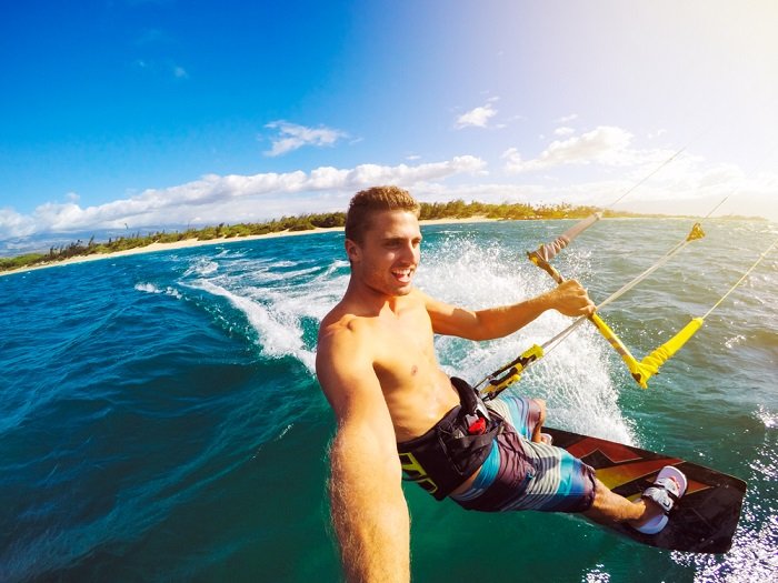 Man using an action camera while windsurfing