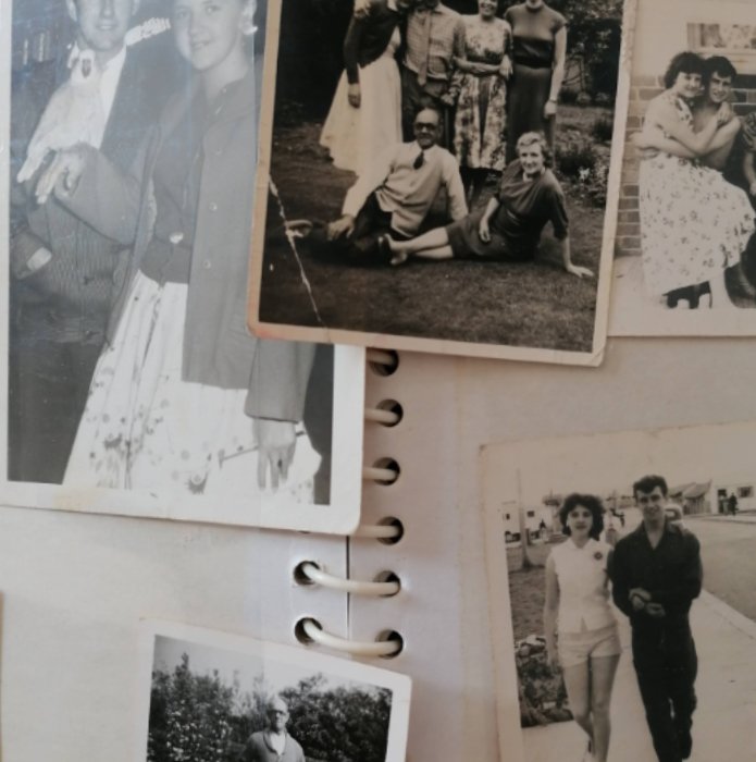 Photo album with old photos falling out of it