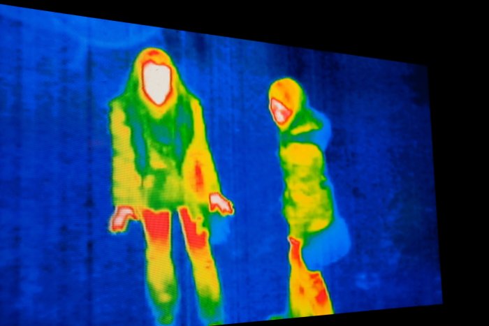 A thermal image of two people