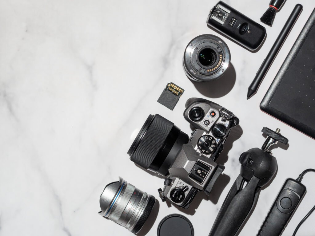 Flat lay of accessories and the best camera for professional photography
