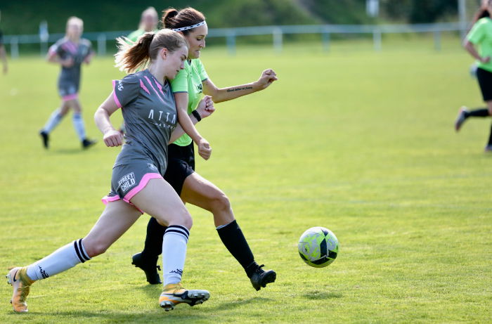 Two footballers contesting the ball