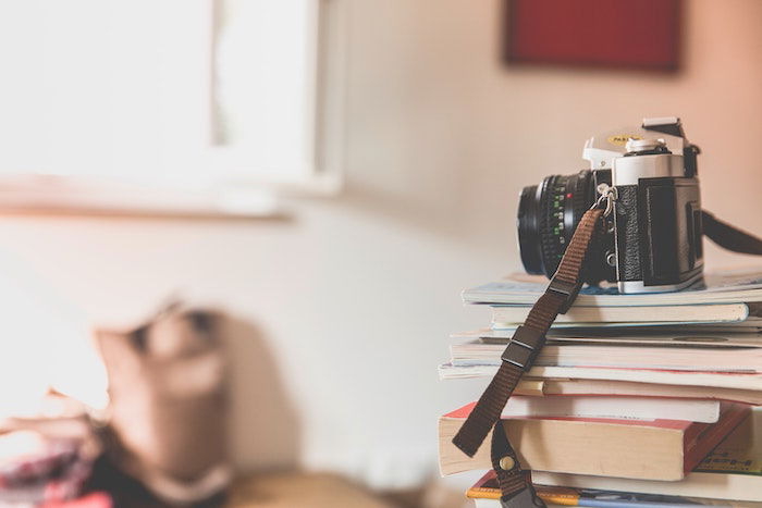 Camera sitting on top of photography books