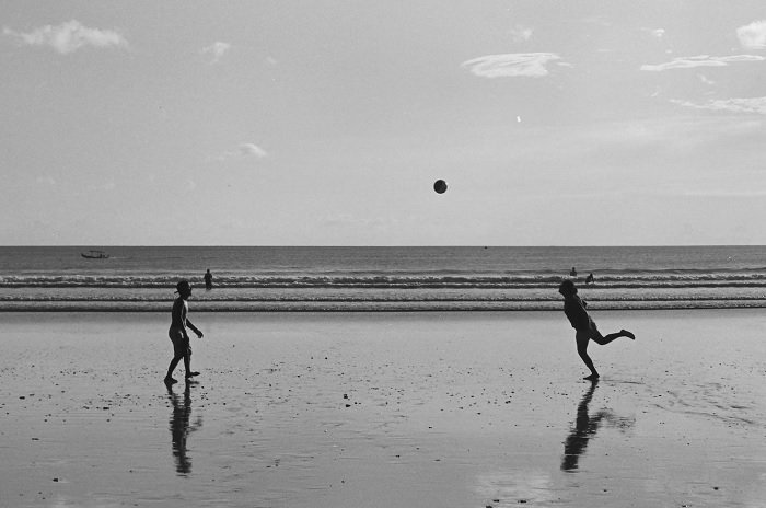 Two people playing volleyball on a beach shot on Kodak T-Max 100