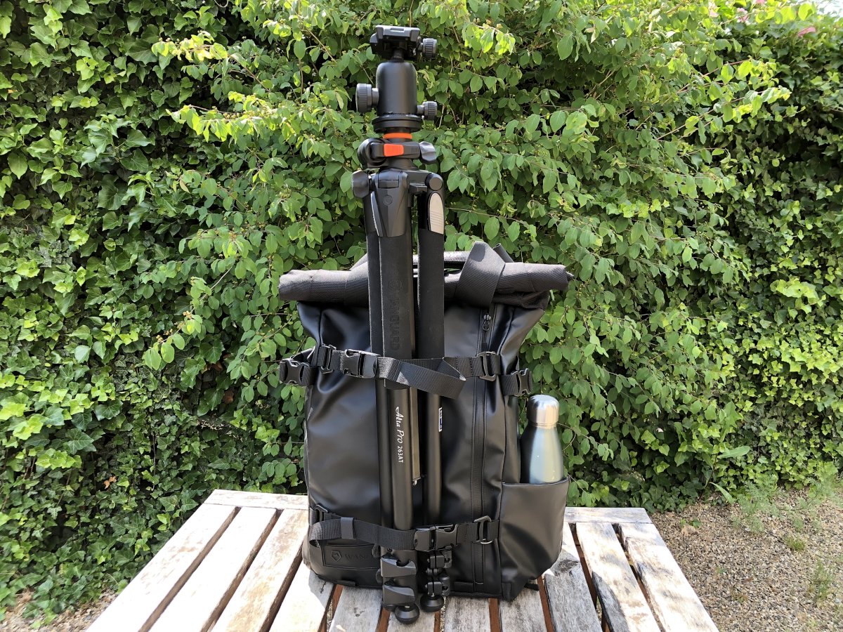 A Wandrd Prke camera backpack with one of the best tripods attached