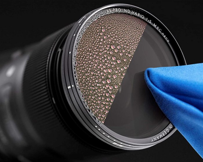 A photo of a neutral density filter being cleaned with a cloth to show the nano coating