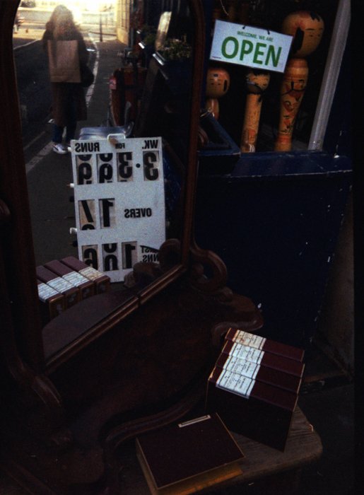 An image of an antique store front shooting into a desk with a mirror
