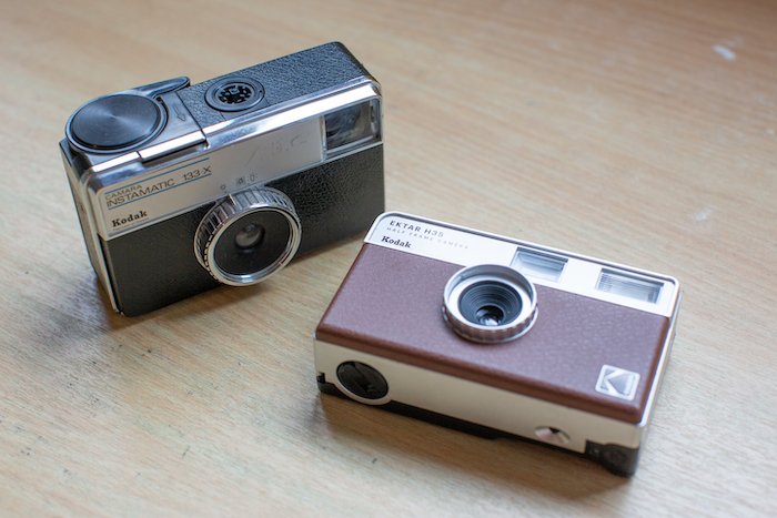 A Kodak Instamatic and the new Kodak Ektar H35 on a desk
