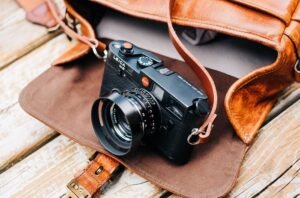 Leica M6 resting on an open leather messenger bag