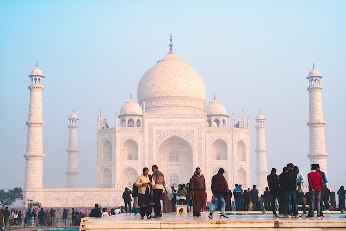 People standing in front of the Taj Mahal in India