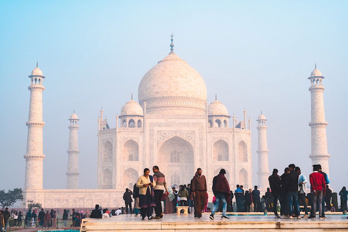 People standing in front of the Taj Mahal in India