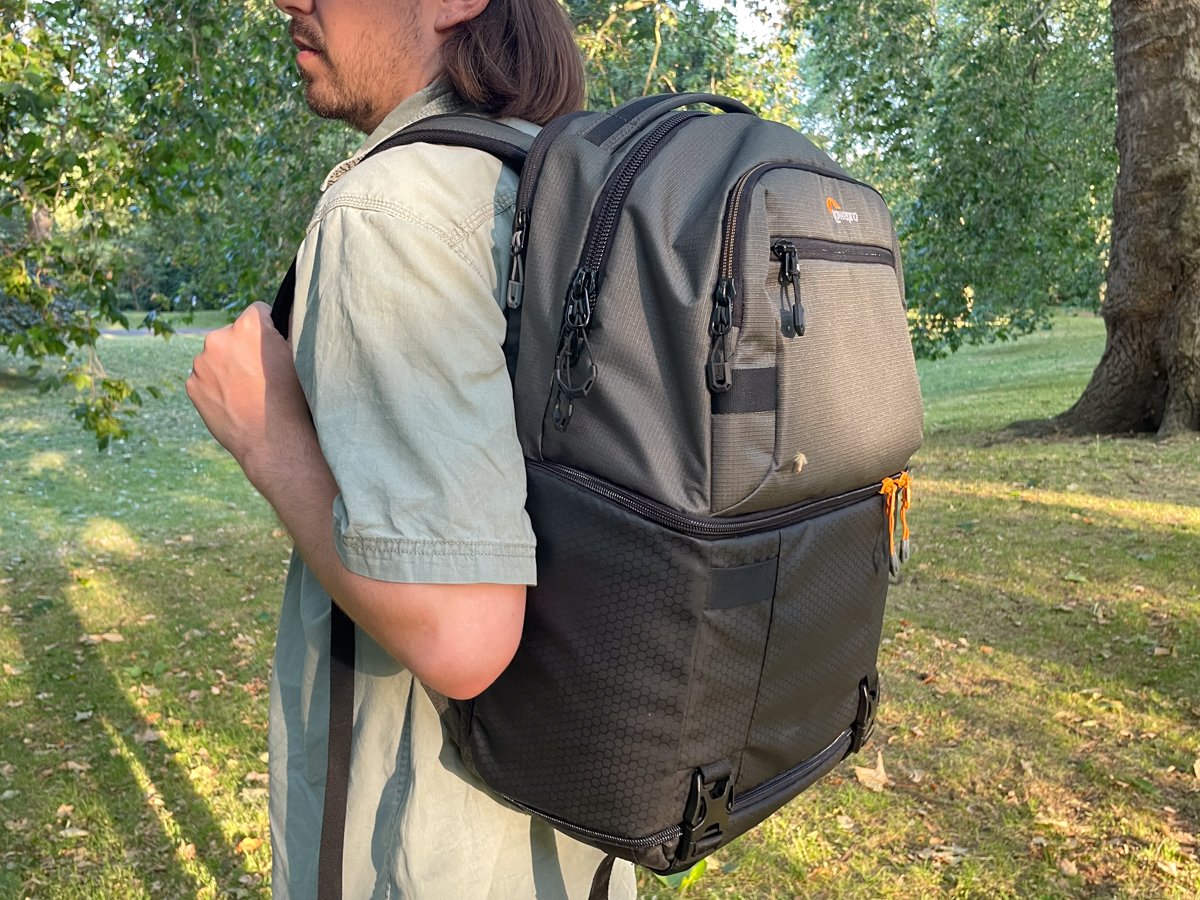 The Lowepro Fastpack Pro BP 250 AW III being worn over one shoulder outside