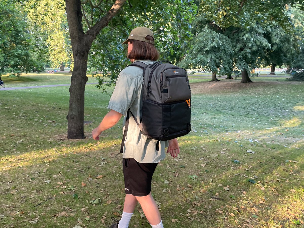 Lowepro Fastpack being used outside in a park