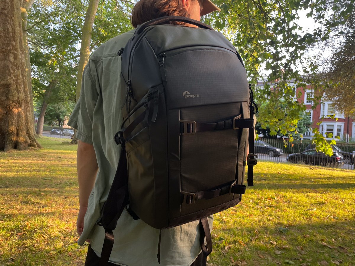 The Lowepro Freeline BP 350 AW camera backpack being worn on one shoulder outside