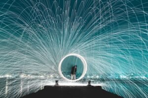 Long-exposure photo of man swinging a sparkler in a circle