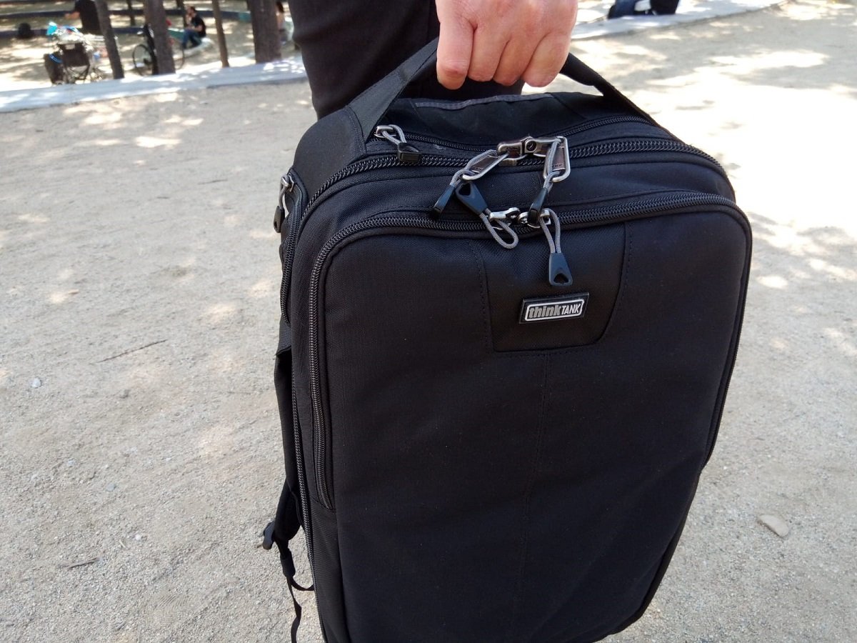 Backpack being carried with top handle