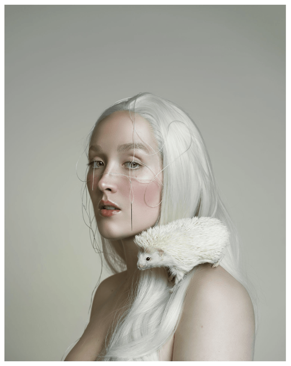 Portrait of a woman with a hedgehog on her shoulder