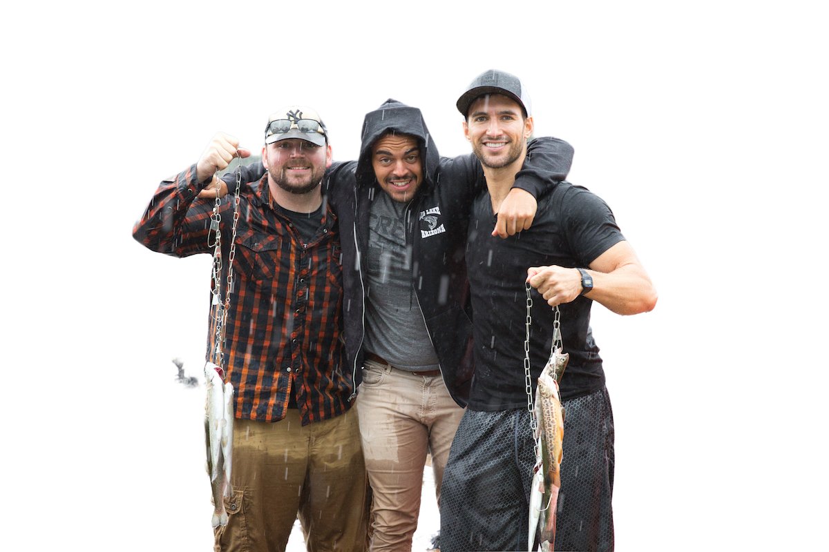 Three guys posing with fish caught with most of the background removed