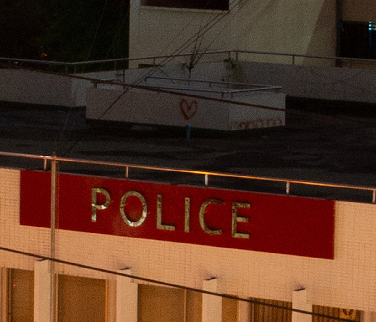 Unedited RAW image of rooftop and police sign