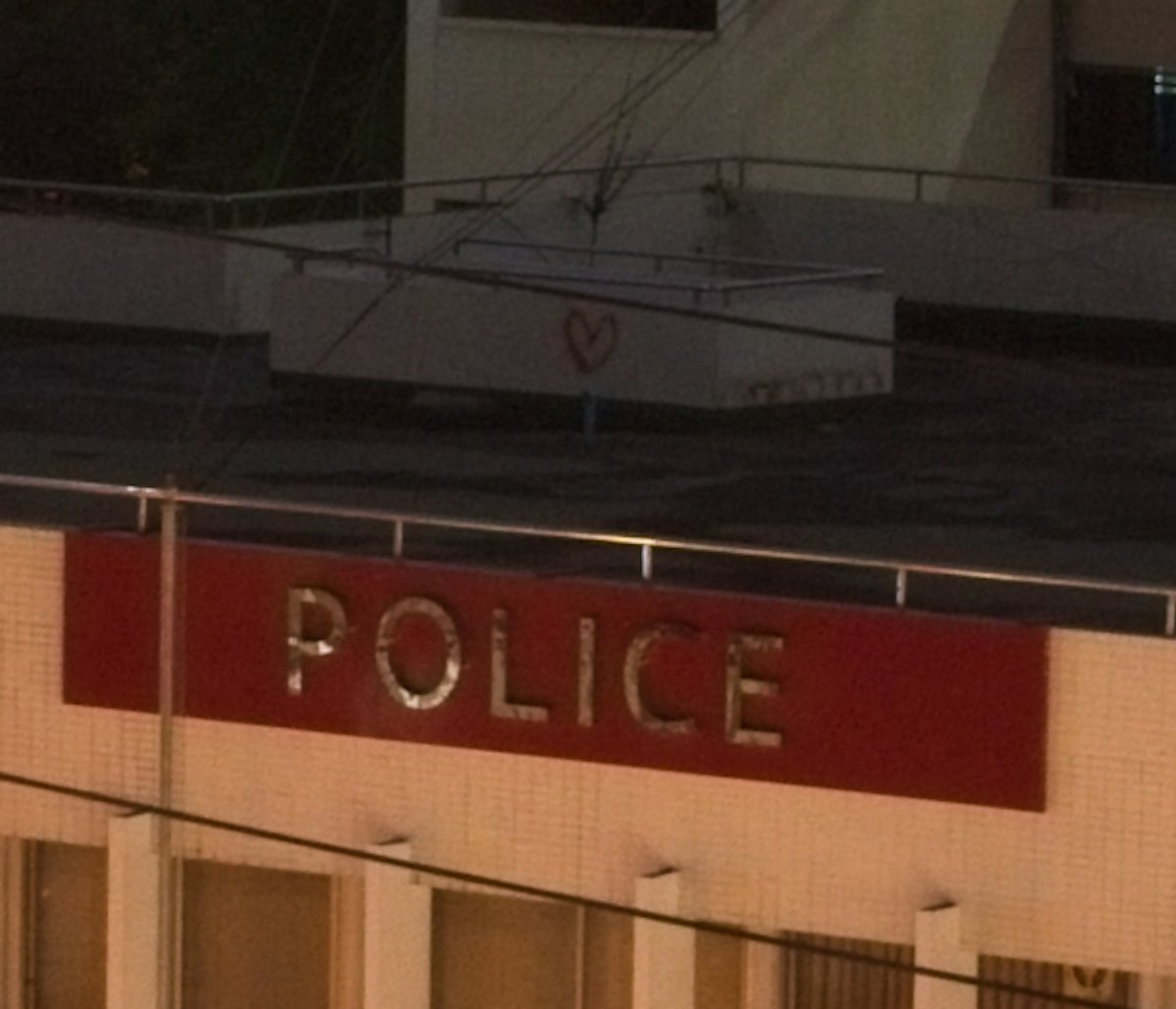 Unedited ON1 RAW image of rooftop with a police sign
