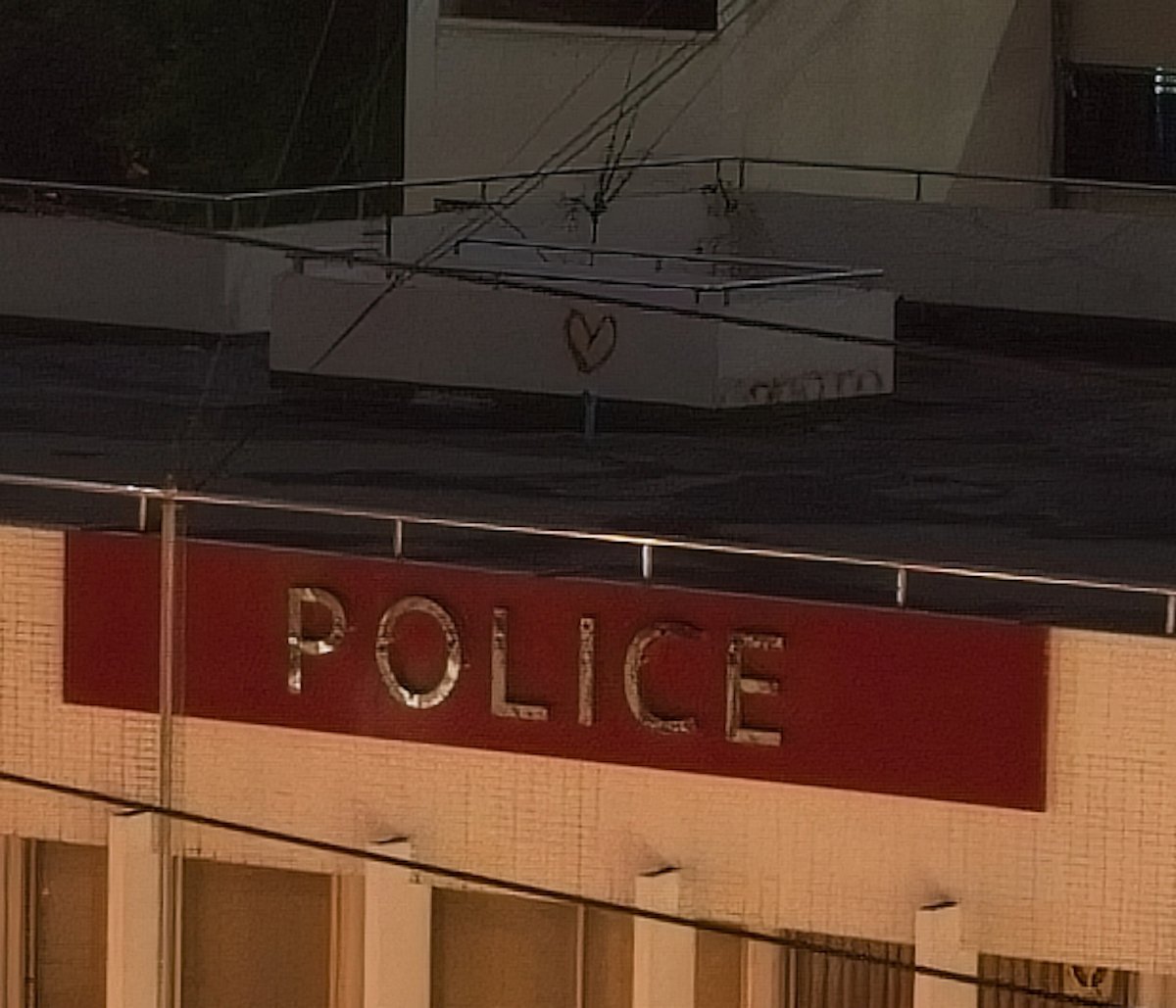 ON1 image of rooftop and police sign with noise reduction